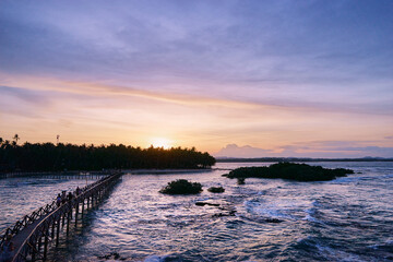 Beautiful landscape. Sunset on the seashore. Wooden bridge on Cloud 9 beach, Siargao Island Philippines.