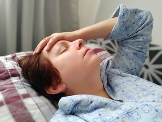 Sick woman in bed. Headache, runny nose and cold. Paleness of the face and faintness of the body....