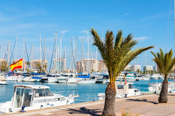 A beautiful marina with luxury yachts and motorboats in the tourist seaside town in Spain