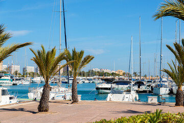 A beautiful marina with luxury yachts and motorboats in the tourist seaside town in Spain