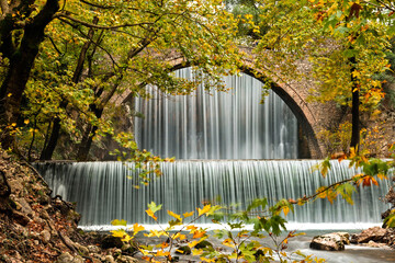 The old stone, arched bridge, between two waterfalls in Palaiokaria, Trikala prefecture, Thessaly, Greece.
