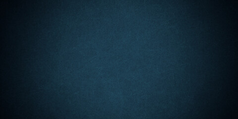 Dark blue background texture with black vignette in old vintage grunge textured border design, dark elegant teal color wall with light spotlight center
