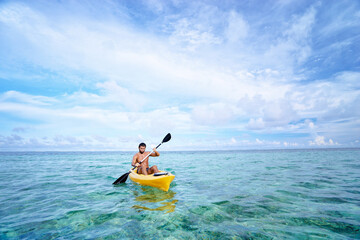 Active water sport and leisure, kayaking. Man Paddling Canoe Kayak In Tropical Ocean, Enjoying Recreational Sporting Activity.