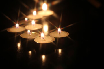 Light several candles on a wooden table