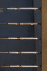 Close-up detail view of a of connector screws of a steel cable railing