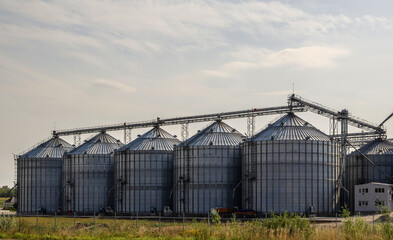 Fototapeta na wymiar Agricultural complex. Elevator for grain storage. Grain warehouse.