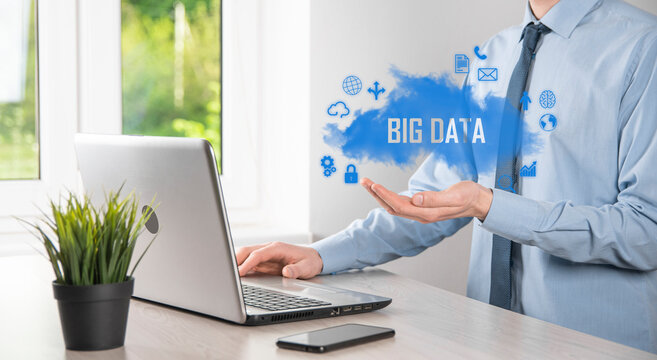 Businessman holds the inscription , word BIG DATA. Padlock , brain ,man, planet,graph, magnifier, gears, cloud, grid, document, letter, phone icon.