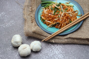 Thai food Pad Thai Thai stir-fried noodles (national dish) served in blue plate.