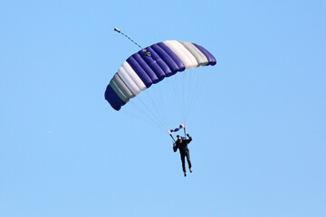 Skydiver in a blue sky	