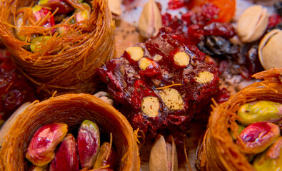 Pistachios in baskets, dried fruits, baklava, Turkish delight from a close distance. Oriental sweets