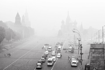 Moscow Kremlin and St Basil`s Cathedral in mist or haze, Russia. Black and white photo.