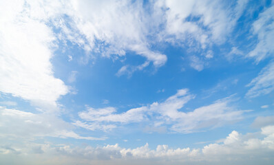 Clear blue sky with white fluffy clouds at noon. Day time. Abstract nature landscape background.