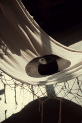 Hat on textile background with shadows