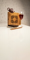 a tea table with tea and a wine glass in which Sheng Pu'er tea is poured to demonstrate the color