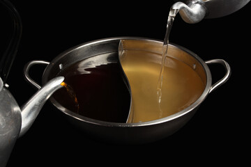Shabu-shabu pot, two types of soup, black background