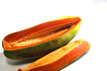 Fresh ripe red papaya isolated on white background. a big papaya with a slightly oval shape is ready to eat on white background. Healthy eating and vegan concept