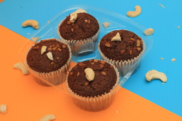 Chocolate muffin isolated on color background. Delicious chocolate muffin with nuts.