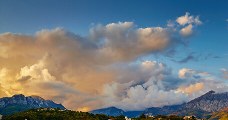 View of the mountains of Italy at sunset, Ventimiglia at sunset through the villa and forest, orange and pink clouds