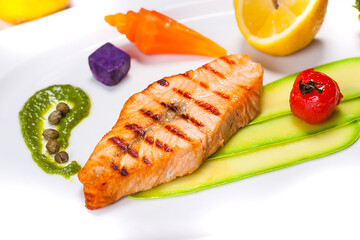 Special fish plate made by a restaurant chef with broccoli lemon avocado and tomatoes