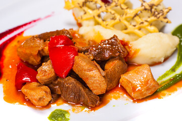 Special dish prepared by a restaurant chef. Composition with beef meat and 2 different sauces