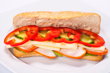 Sandwich plate made by a restaurant chef. Composition with bread pepper cucumbers cheese and salad.
