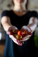 girl holding cherry tomatoes