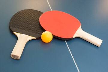 Ping pong table, two paddles and balls in a gym on a table .Sports health and lifestyle