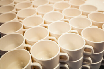 a white stack of coffee cups arranged one on top of the other