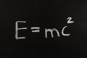 The calculation for mass energy equivalence ist standing on a chalkboard, physic formular