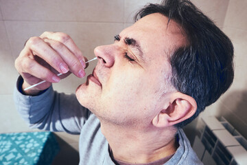 A man doing the rapid antigen test at home, sars-cov-2, coronavirus, covid-19.