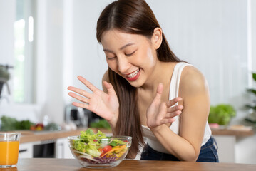 Obraz na płótnie Canvas Smiled happy woman eating a bowl of salad as breakfast for good health.