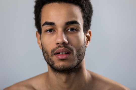 Portrait of attractive african american man with stubble and bare shoulders.
