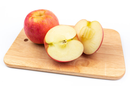 delicious fruit Red ripe apples and cut apples on a cutting board on a white background.