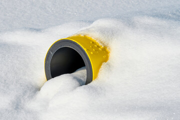Yellow Jacketed Pipe under the snow.