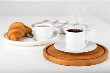 Coffee croissant on wooden background empty.