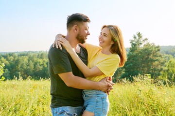 Outdoor portrait of happy middle age couple in love embracing