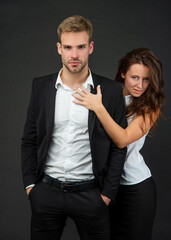 successful businessman and sexy businesswoman on black background, couple