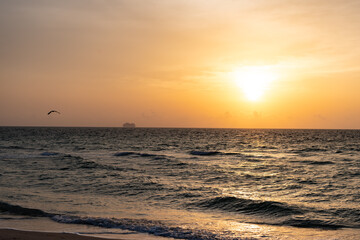 Seascape with sea waves rolling during sunset under evening sky