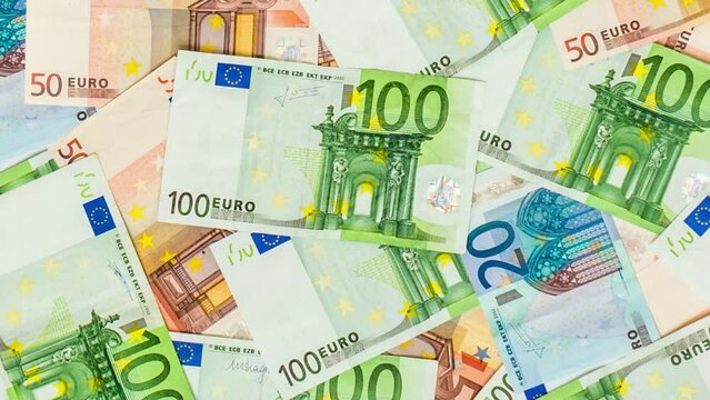 Pile of paper euro money banknotes on background