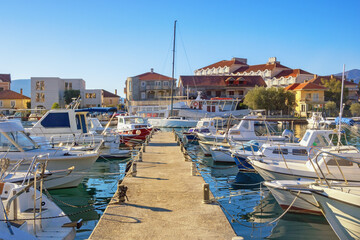 Fototapeta na wymiar Fishing boats at pier. Montenegro. View of Marina Kalimanj in Tivat city