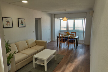the living room, with its sofa, chairs, table of a house in Spain