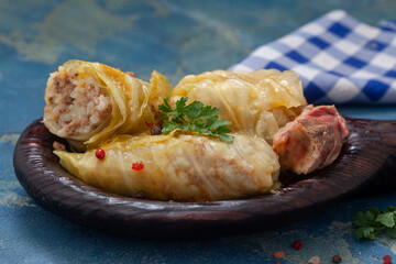 Cabbage rolls with minced meat and rice in wooden plate. Serbian sarma, Turkish dolma,  golubtsi or golabki.
