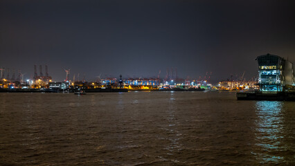 Fototapeta na wymiar Hamburg, Germany. View of the harbor and the river Elbe at night.