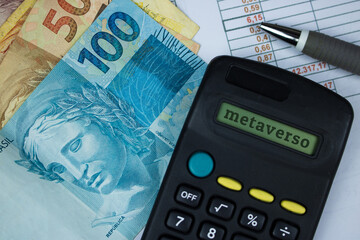 Metaverse written in portuguese in calculator with brazilian money background. Modern Metaverse Finance image.
