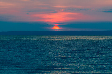 Evening sky with dramatic clouds over the sea. Dramatic sunset over the sea.