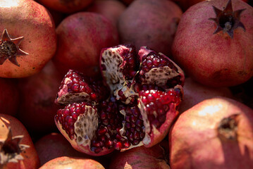 Pomegranate garnet fruit background pattern. Fresh raw organic garnet fruit pile texture...