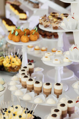 Beautifully decorated table with sweets and desserts for holiday guests