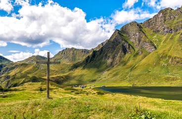 Old wooden cross in the park of the alpine lakes, Cadagno. Piotta, canton Ticino of Switzerland.