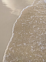 Fototapeta na wymiar sea foam on snow-white sand
