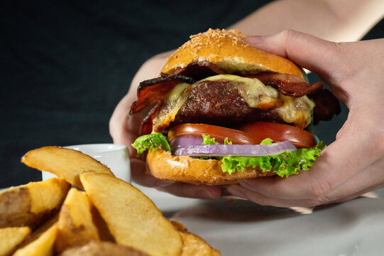 big hamburger in the hands, ready for eat